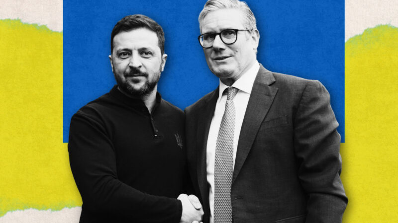 Volodymyr Zelenskyy and Keir Starmer, side by side, shaking hands and looking at the camera.