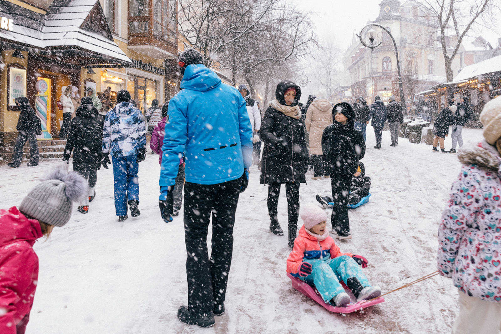 Tourists walk along Krupówki Street during a snowfall in Zakopane, Poland, on January 10, 2025.