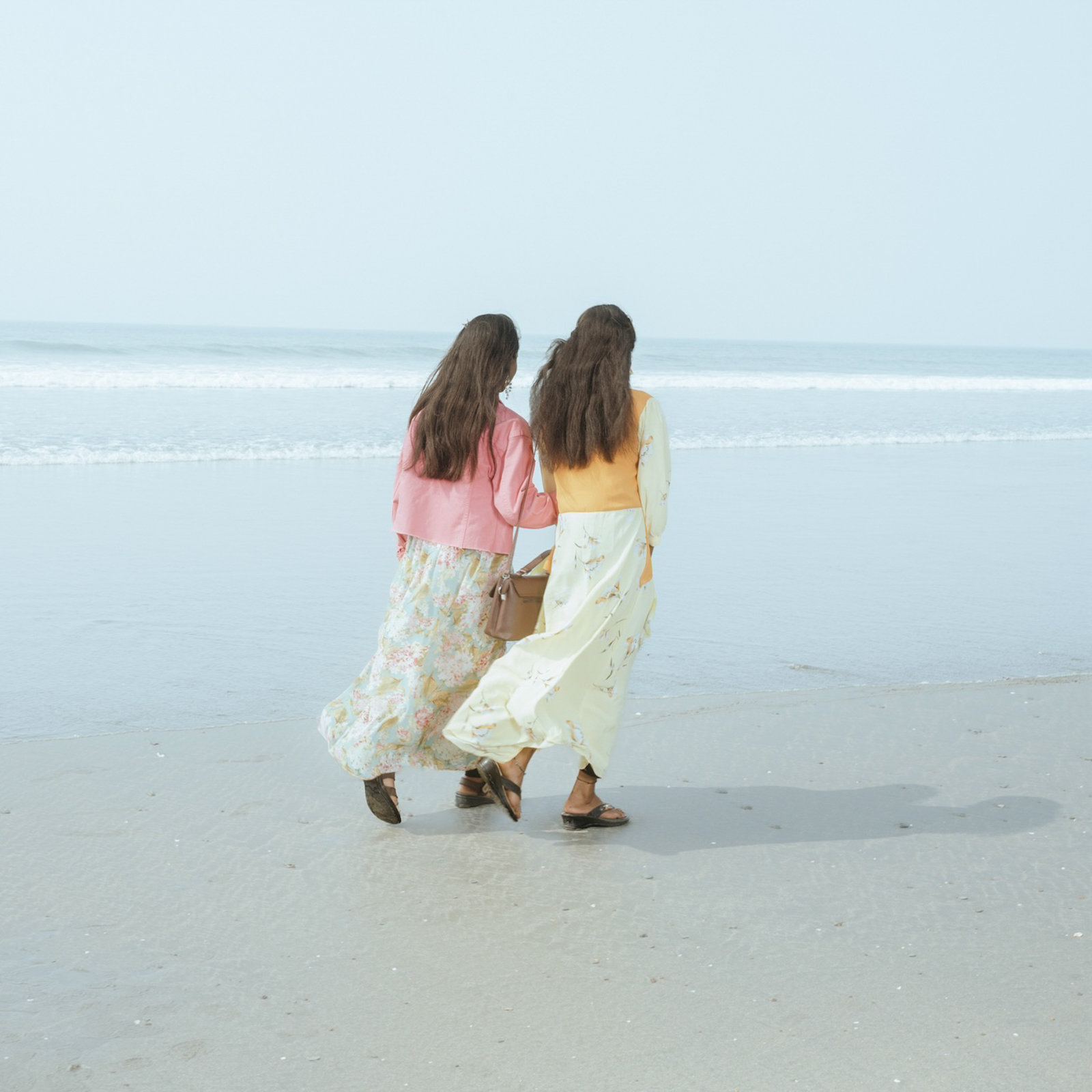 Two tourist sisters taking a walk in the beach of Cox’s Bazar