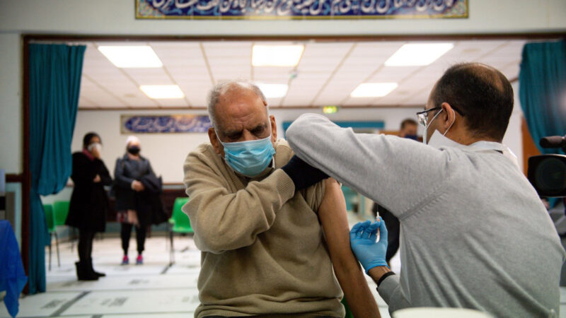 A man receives the Covid-19 vaccine in his arm