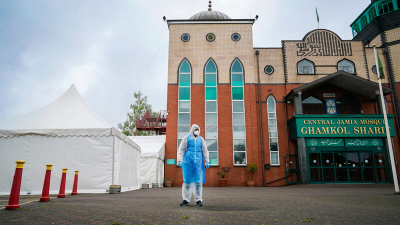 Volunteer in PPE outside a mosque being used to give vaccinations during the Covid pandemic
