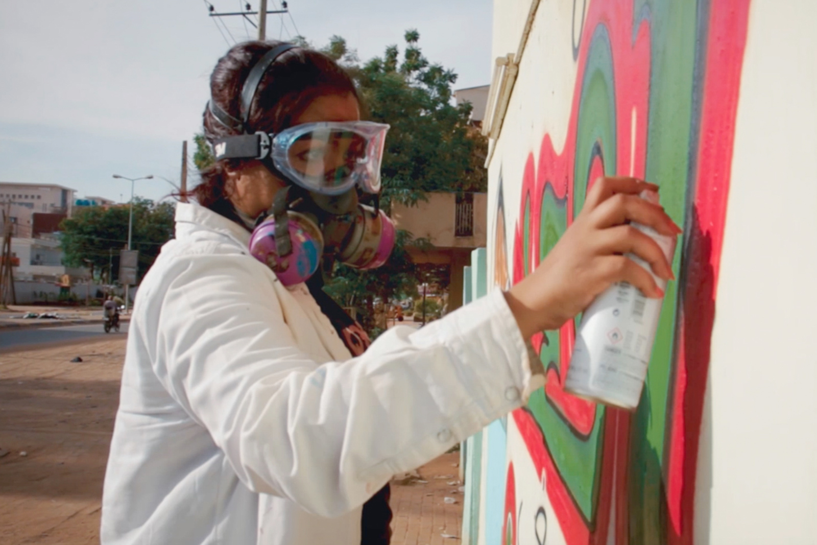 Sudanese artist Assil Diab spray painting in Khartoum. Photograph courtesy of Foxtrot Films