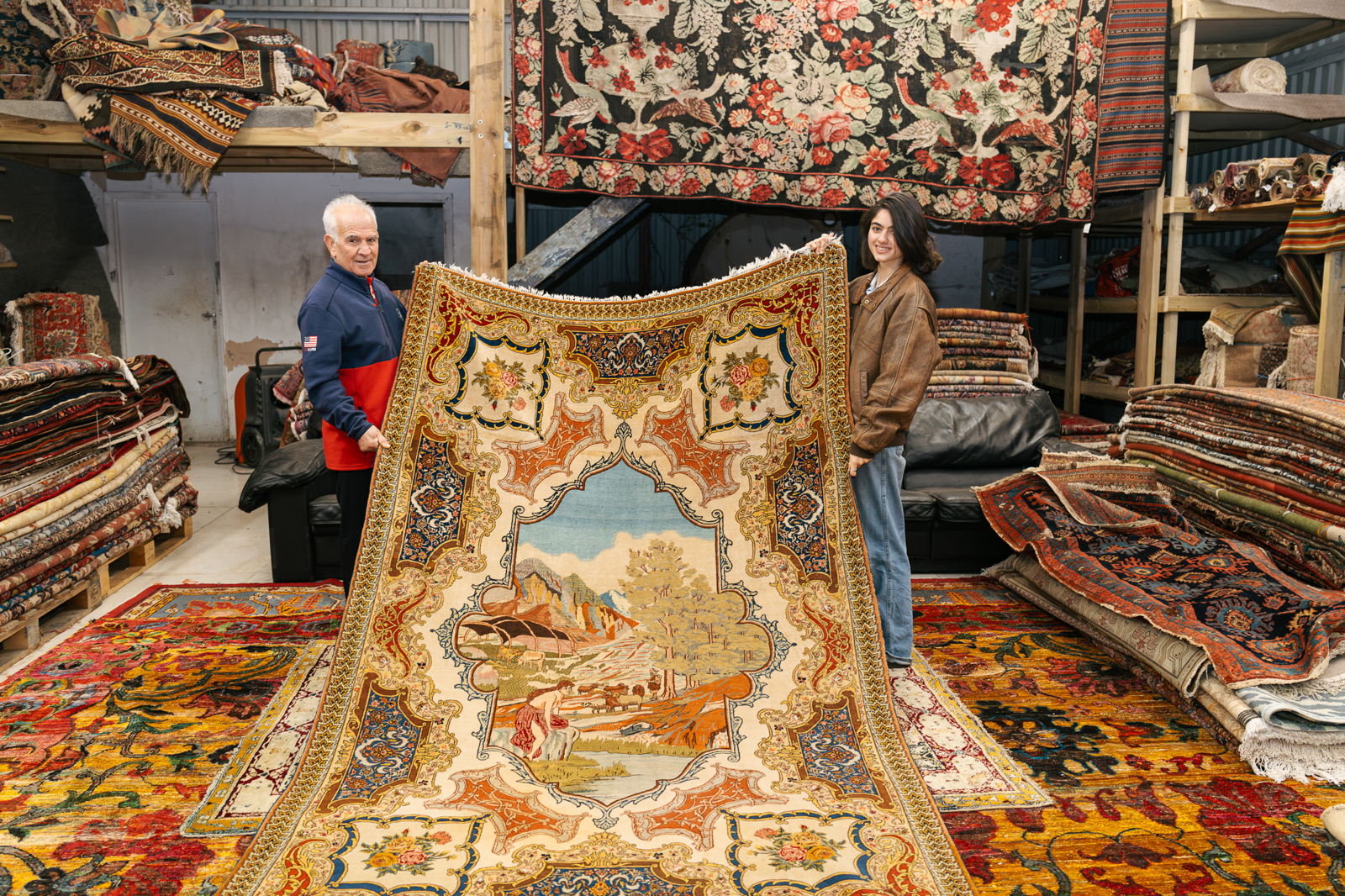 A pictorial rug, made in Tabriz, Iran, held by Thames Carpets owners Bahram (left) and Sophie Javadi-Babreh