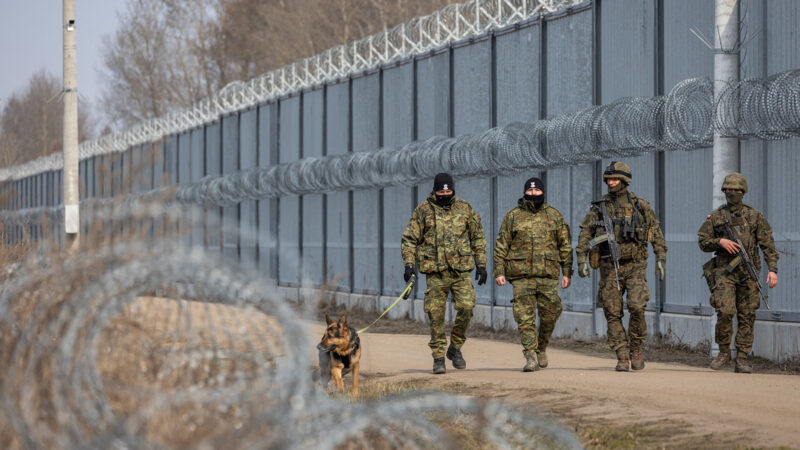 Polish border guard officers and soldiers patrol beside a fence built to curb irregular immigration at the Belarusian border in Ozierany Male, eastern Poland, on March 22, 2025.