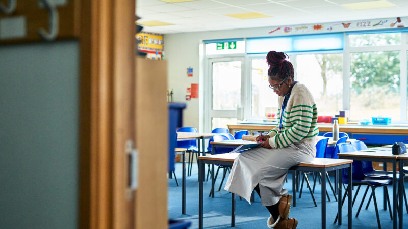 A teacher alone in a classroom