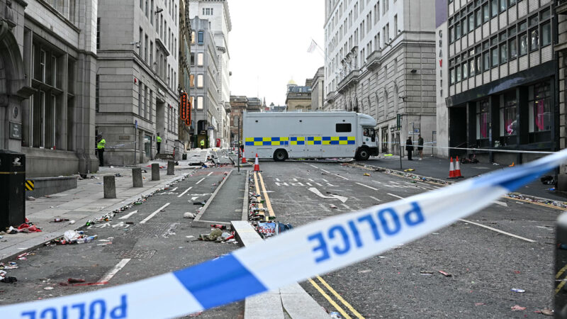 Police officers stand at a cordon on in Water Street in Liverpool, north-west England on May 27, 2025, after a car ploughed in to crowds gathered to watch an open-top bus victory parade for Liverpool's Premier League trophy parade. Police said Monday they were not treating a Liverpool car ramming which left 27 people hospitalised as terrorism, after a vehicle ploughed into crowds celebrating Liverpool's Premier League football title. "We believe this to be an isolated incident, and we are not currently looking for anyone else in relation to it," Merseyside Police Assistant Chief Constable Jenny Sims told a press conference, adding a 53-year-old British man had been arrested. (Photo by Paul ELLIS / AFP) (Photo by PAUL ELLIS/AFP via Getty Images)