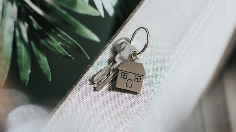 Two house keys on a keyring.