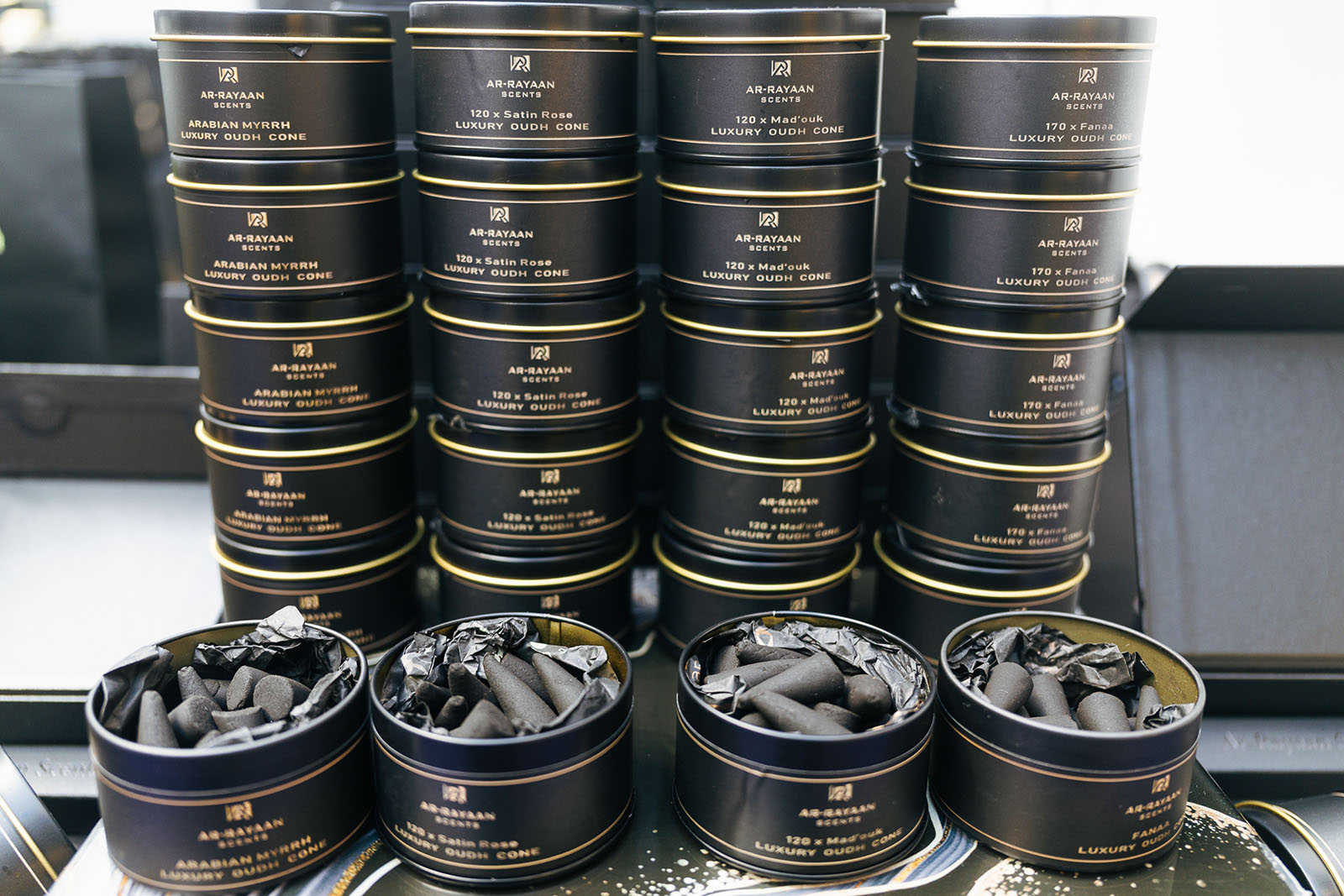 Black tins of Ar-Rayaan Oudh cones