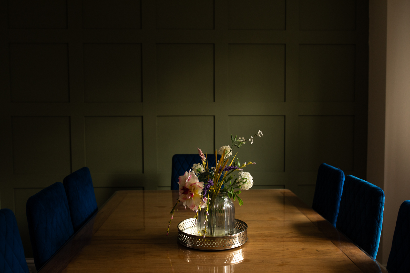 Dining table with a vase of flowers on it