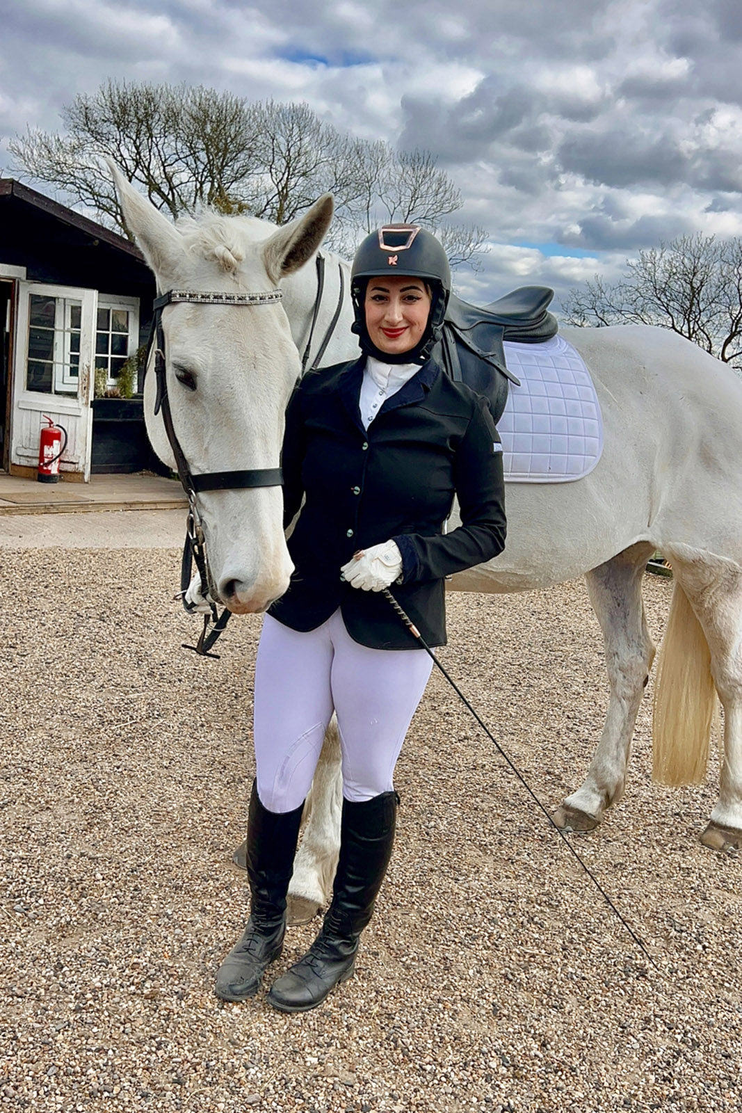 Equestrian rider Noor Hussain with her white horse