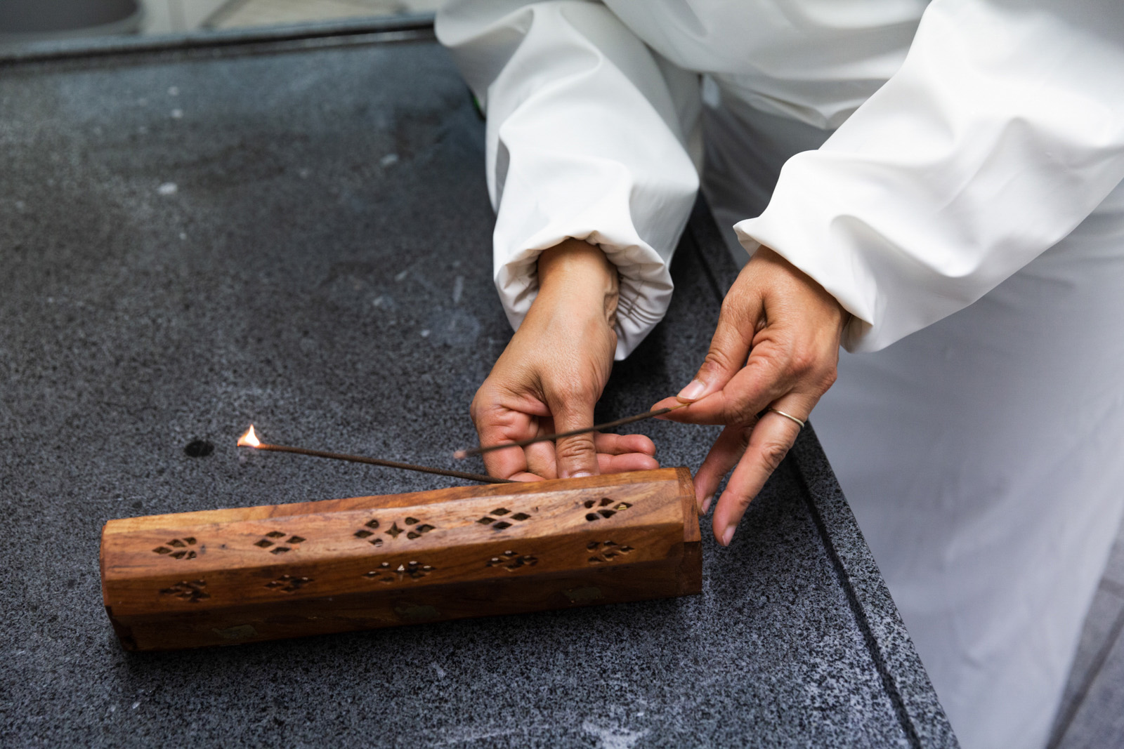 Vildane Uludağ, co-owner of the Uludag Cenaze Muslim burial company in Hamburg, demonstrates how incence sticks would be lit if there was a body to be washed before burial. Transparency: She did it so that we could take pictures.