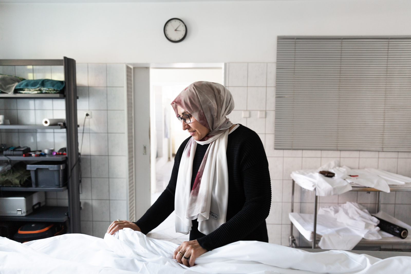 Vildane Uludağ, co-owner of the Uludag Cenaze Muslim burial company in Hamburg, prepares a burial shroud.