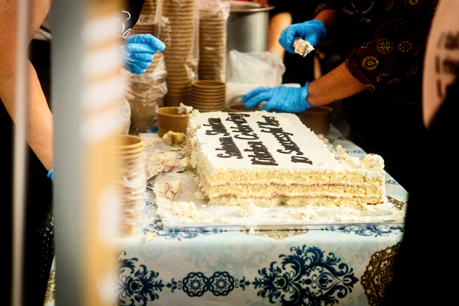 Salaam Shalom co-chair Karen Worth cutting the food bank's 10th birthday cake.