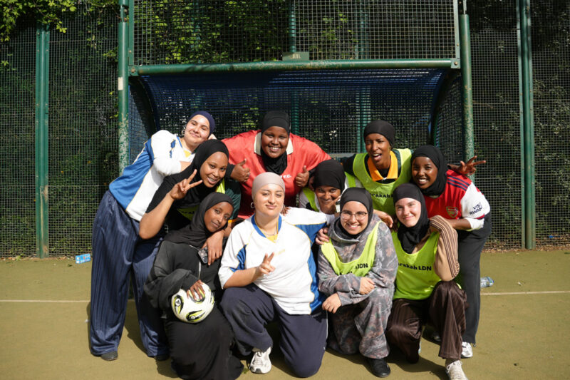 Members of Barakah LDN pose together in front of goal