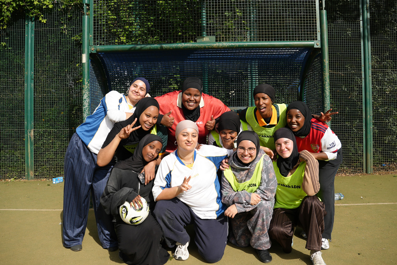 Members of Barakah LDN pose together in front of goal