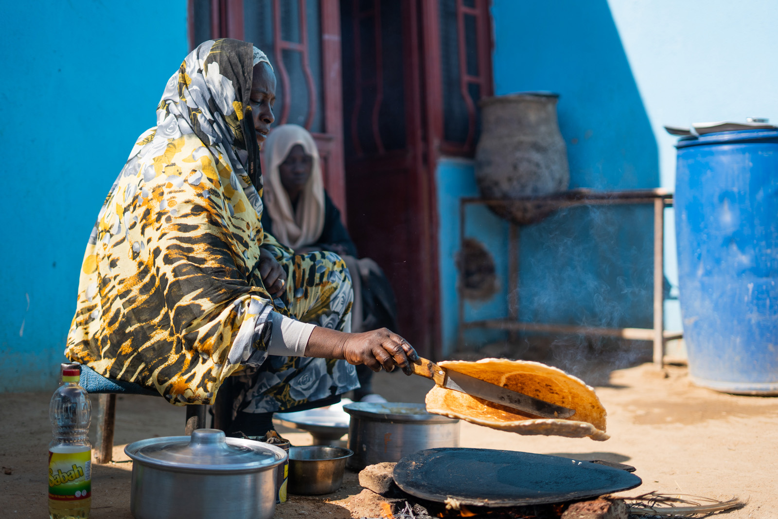 A woman cooking in Sudan, image from The Sudanese Kitchen