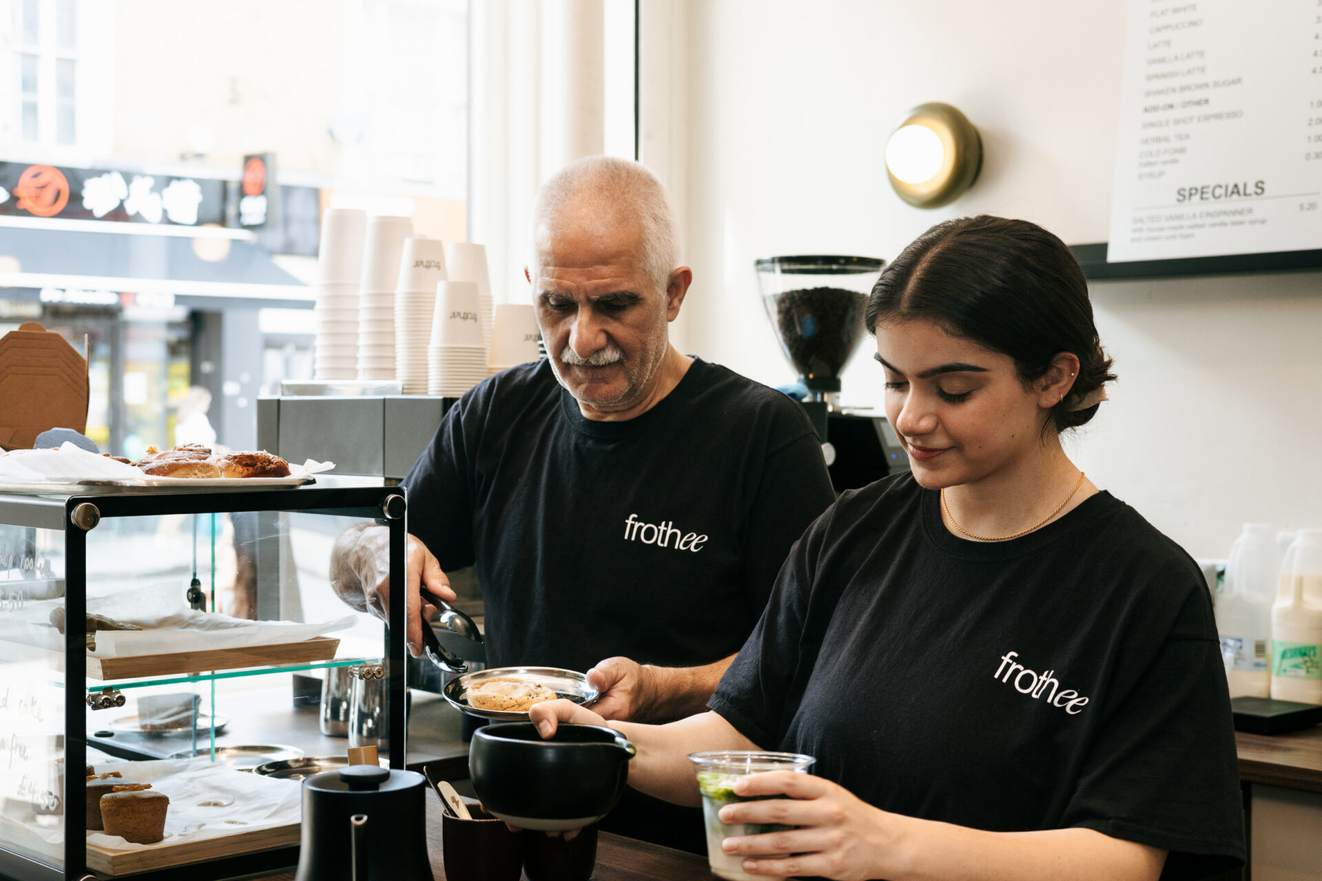 Hanife Hursit and her dad, Ram, preparing customers' orders at Frothee.