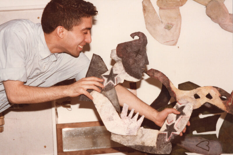 Archive photograph of the artist Hamad Butt with one of his artworks.