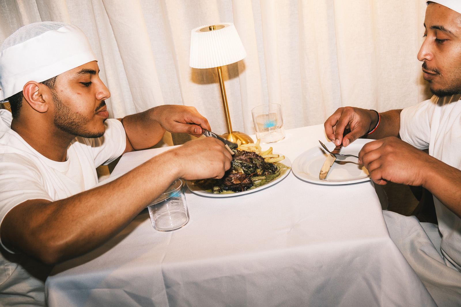 Abdinasir Sharif (left) and his brother. Meal on the table is the beef shortribs and french fries.