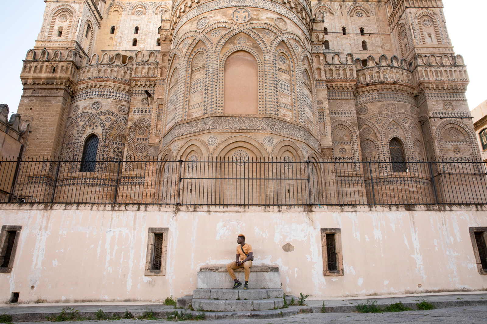 Lamin Drammeh, an actor who arrived in Sicily from the Gambia, stands outside Palermo cathedral.