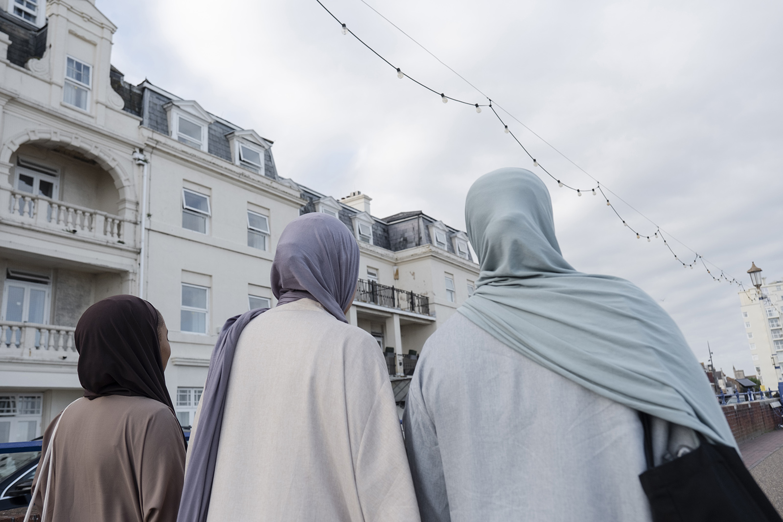 Stock image of three Muslim women walking in city