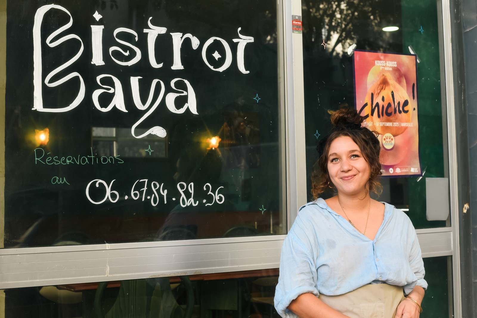 French-Algerian chef Maeva Hocini poses in front of her restaurant Bistrot Baya, located on Boulevard National, close to Marseille's central Saint-Charles station.