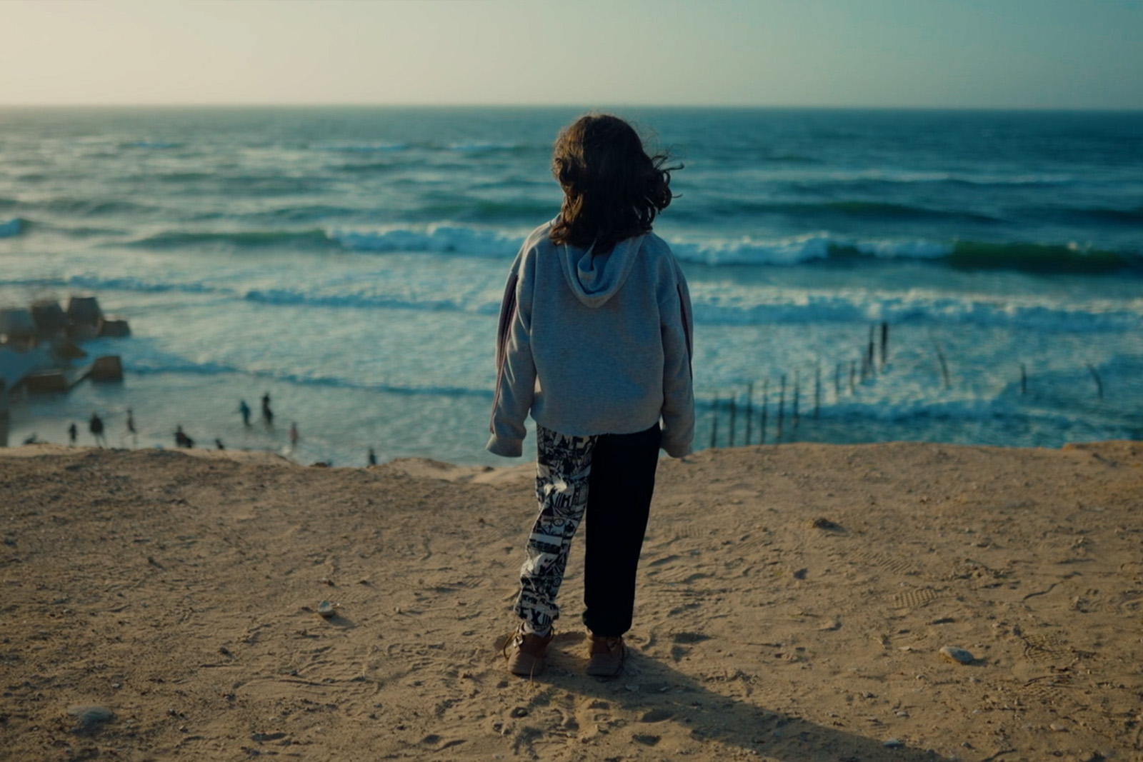 Still from the film From Ground Zero featuring a young girl looking out to the sea.