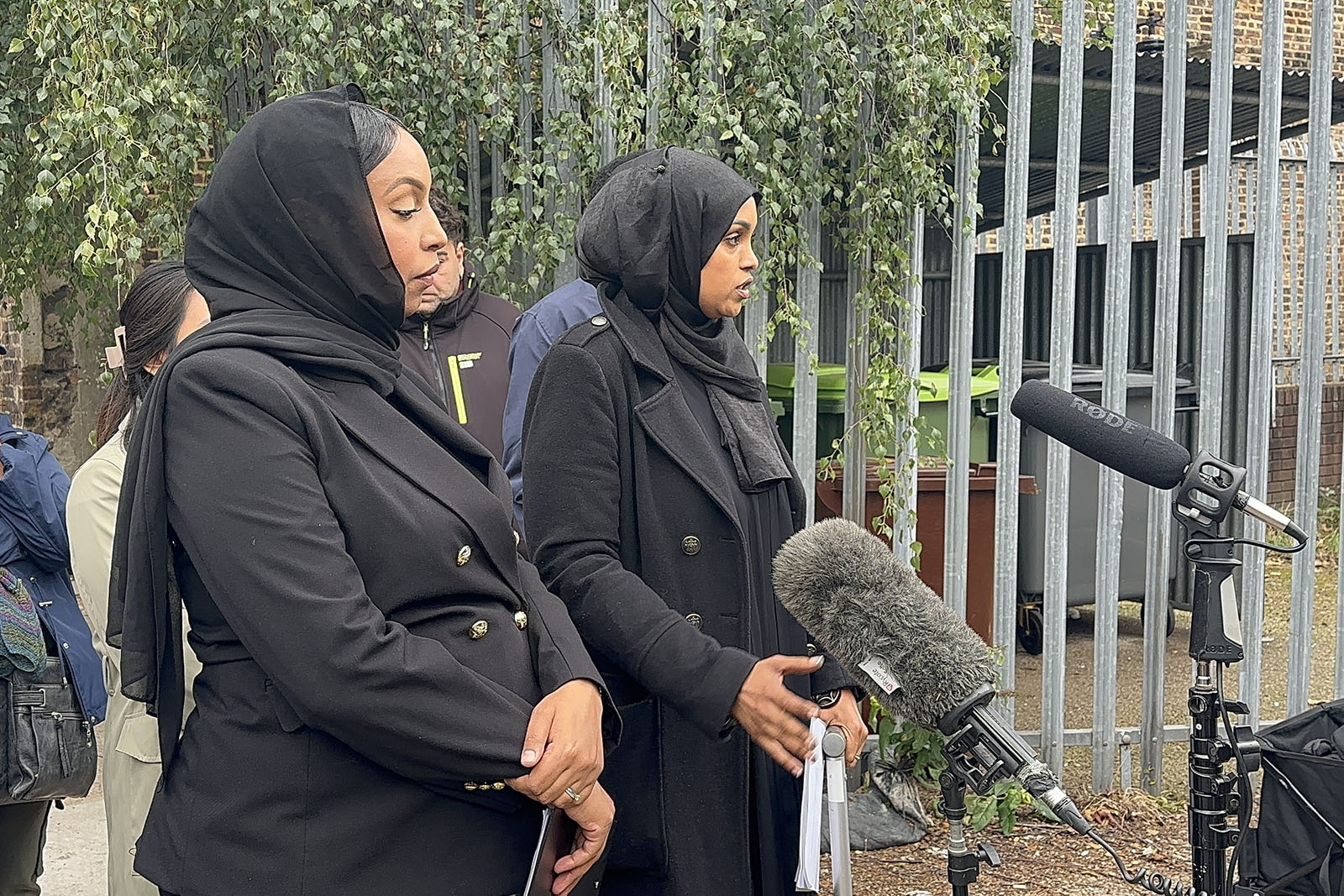 Ayaan Ali Waeys' sister Fowsiyo (left) and Firdous Ibrahim, of law firm Leigh Day, speaking outside the coroner's court on 7 October. 