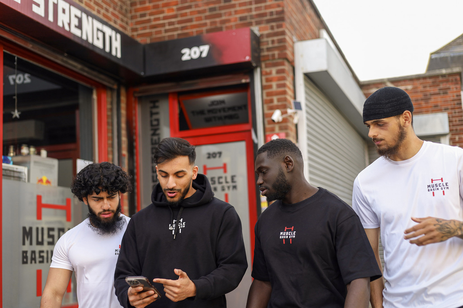 Founders Jahedul Islam (left) and Fahimul Islam (second left) and gym members outside Muscle Basin