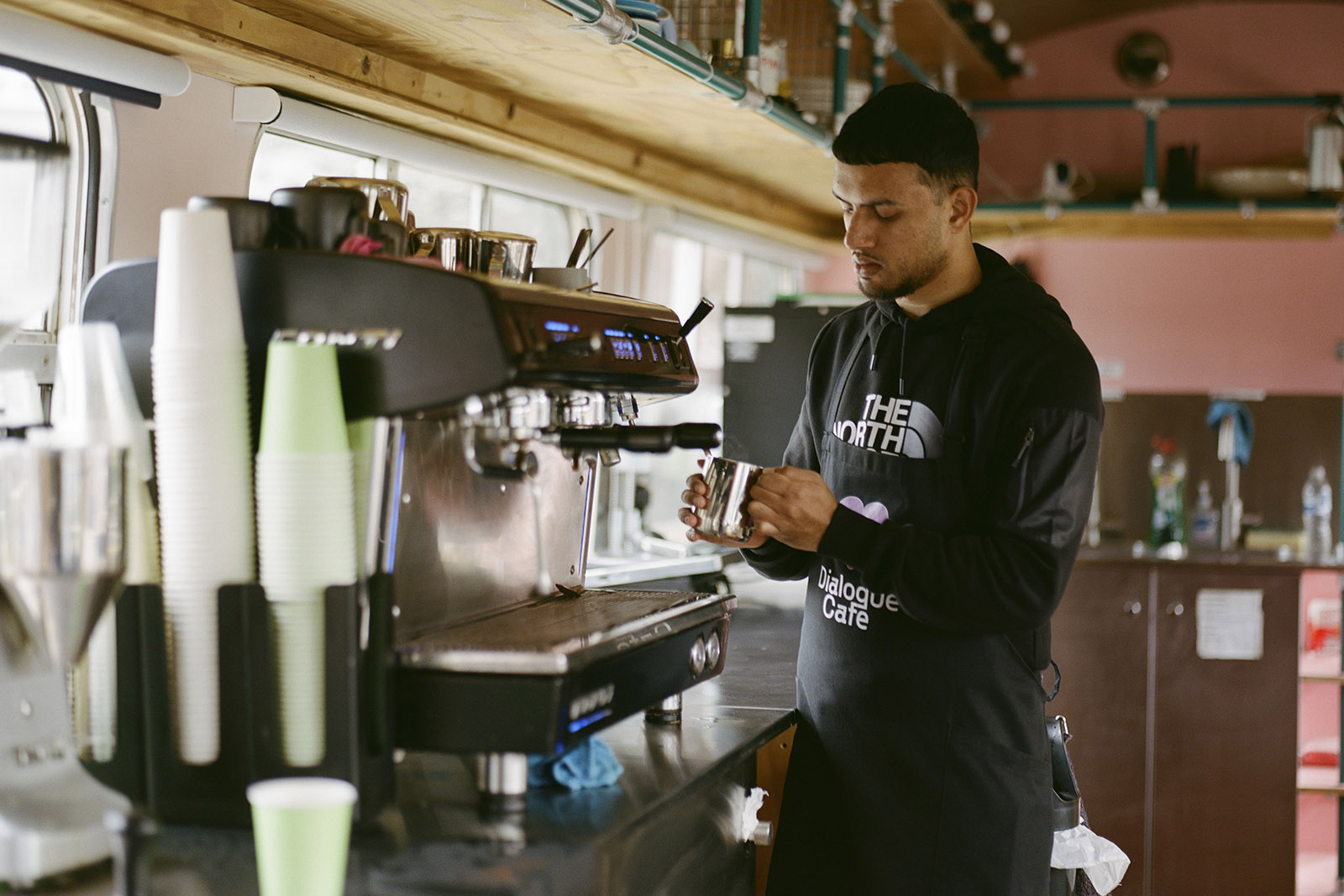 Dialogue Express Cafe barista Mohammed Samian making a drink
