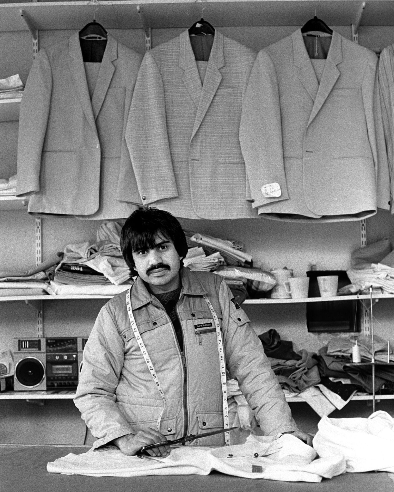 Tailor Barket Ali in his Bradford shop in 1986, in an image featured in the exhibition
