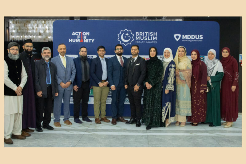 A group of smiling people in formal dress in a line