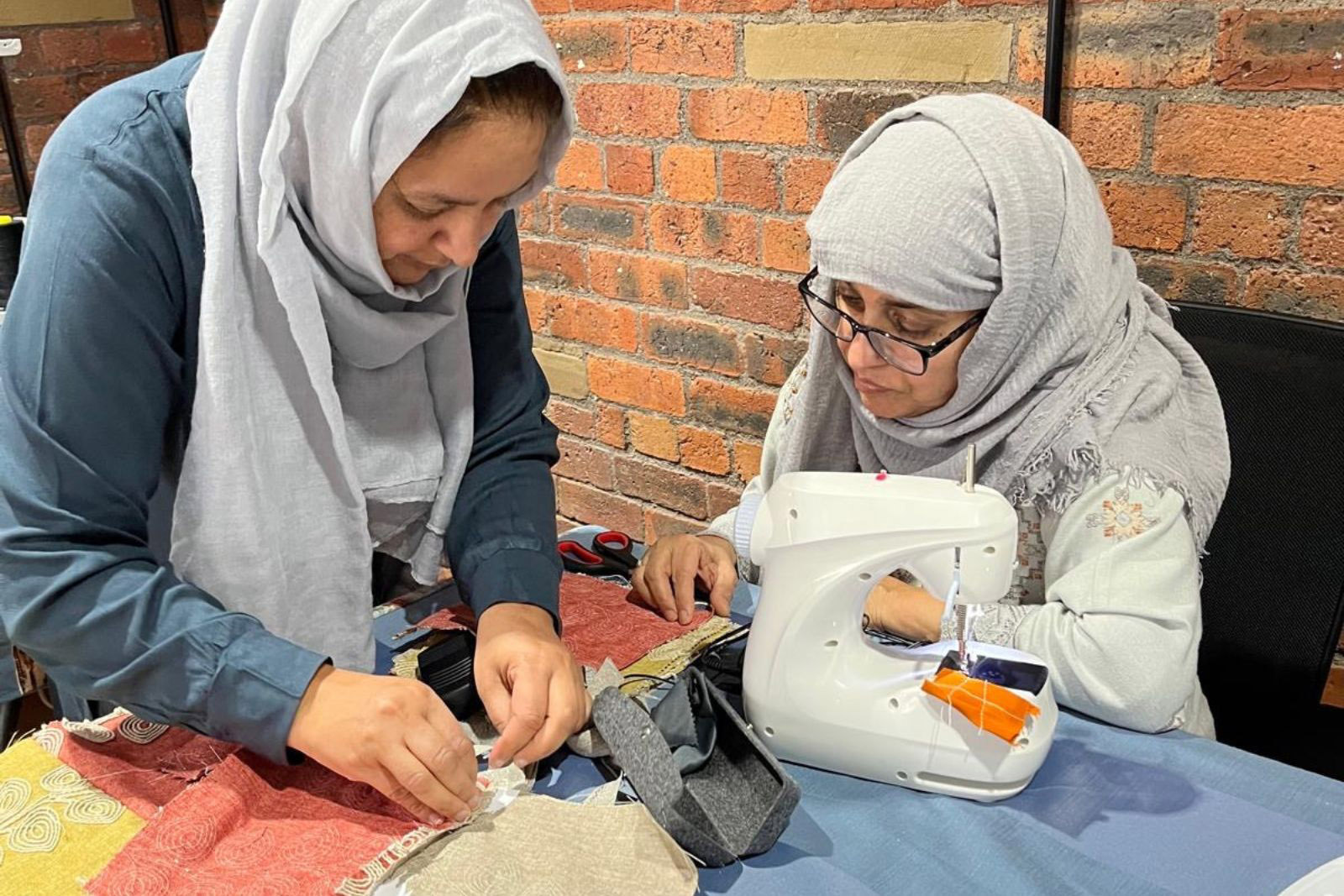 Participants at Sewcialise, the Yorkshire Women's Forum's weekly sewing and textile group at Manningham Mills, Bradford