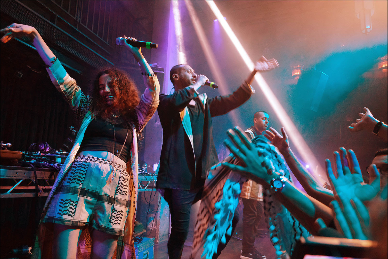 Tamer Nafar (centre) on stage with DAM bandmates Maysa Daw and Suhell Nafar at the Jazz Cafe, London, in 2019