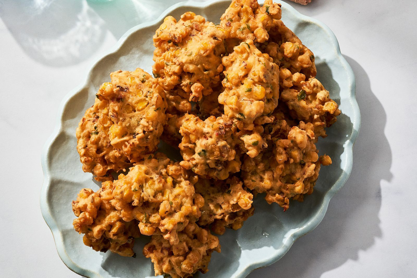 A photograph of a plate of corn pakoras