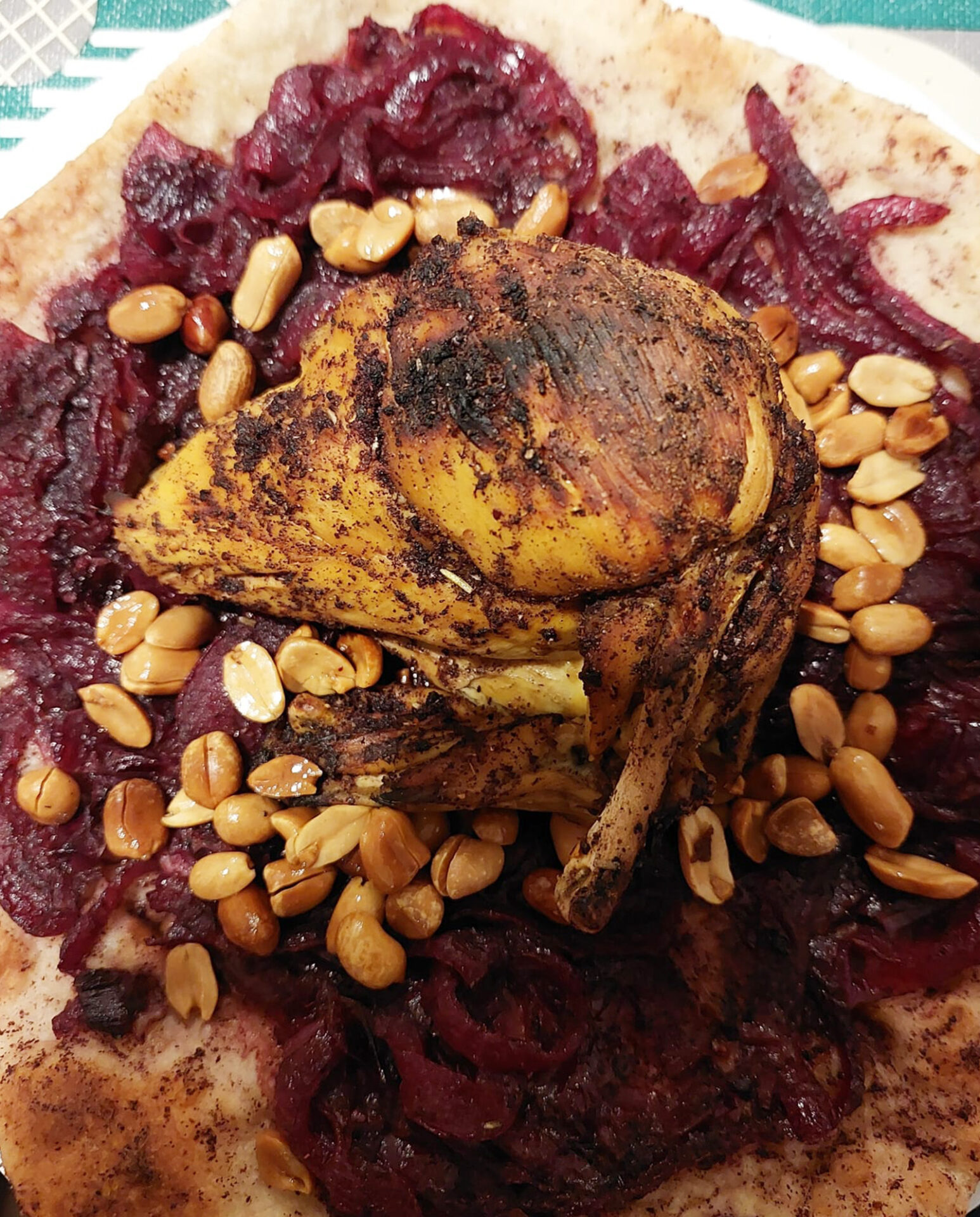 A photograph of Gazzawi Cuisine owner Asma Abu Salama's musakhan dish, with peanuts added as an optional topping