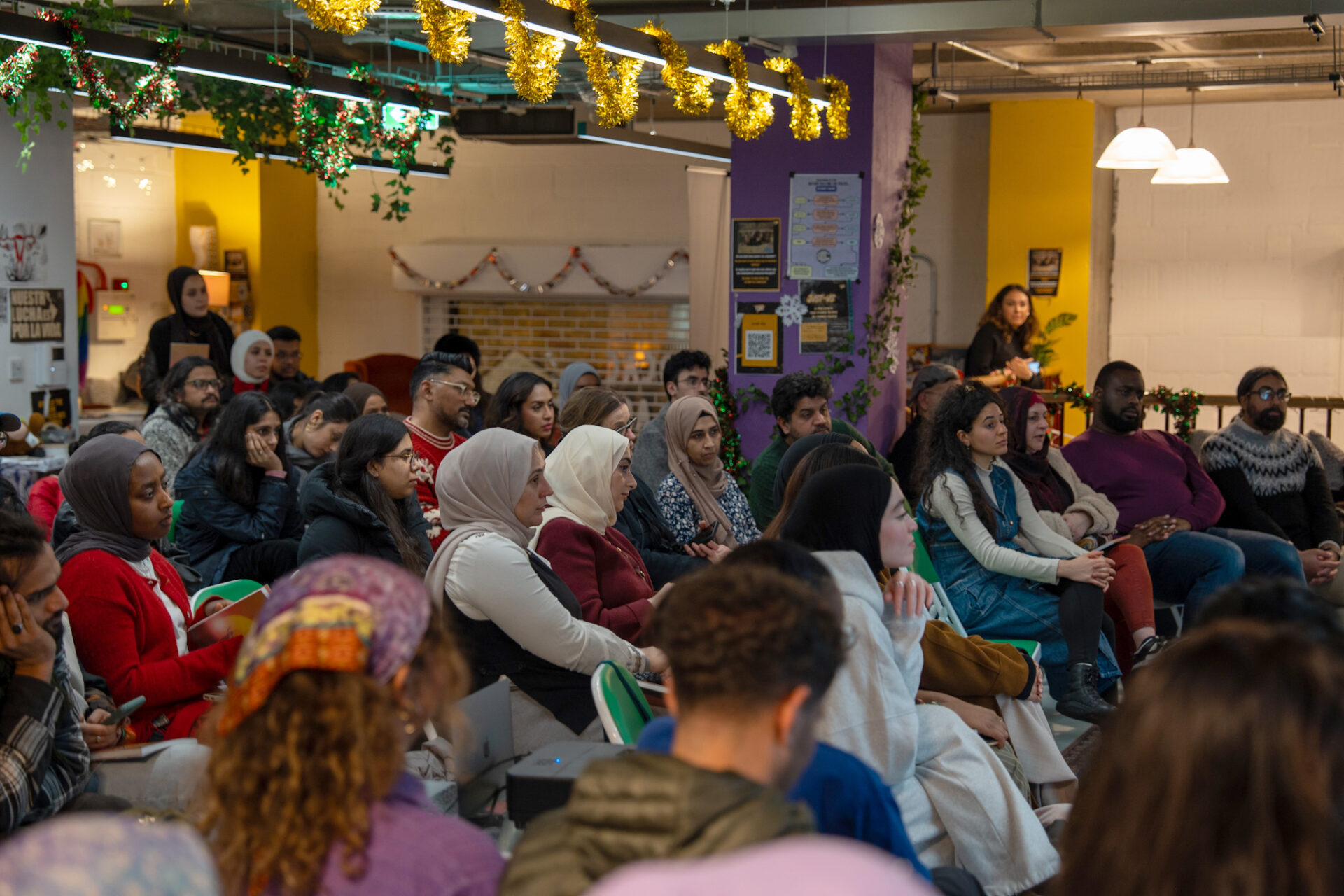 A photograph of people in the audience at the Brixton launch event for Khidr Collective latest zine, Issue 5: Holding Joy, in December 2025.