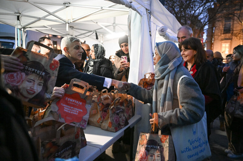 A photograph of London mayor Sadiq Khan shaking hands with a woman as he distributes iftar meals at the Open Iftar event in Trafalgar Square, 16 March 16 2026