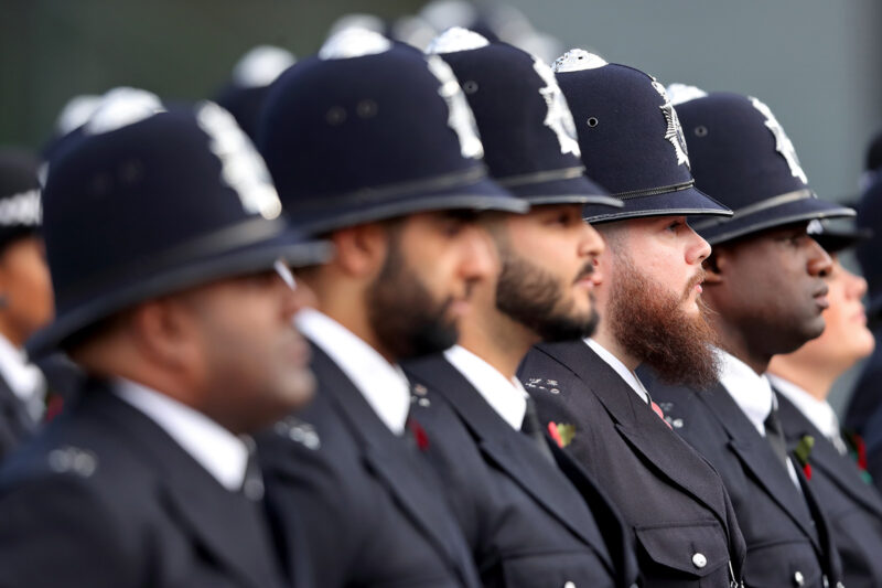 A photograph showing a line of graduating officers in uniform at a Metropolitan Police passing out parade for new recruits