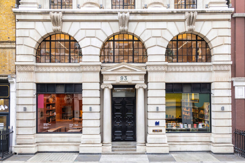 A photograph of the front of Ibraaz at 93 Mortimer Street, central London, an early 20th century building in the neo-Greek style made of Portland stone and framed by Ionic columns