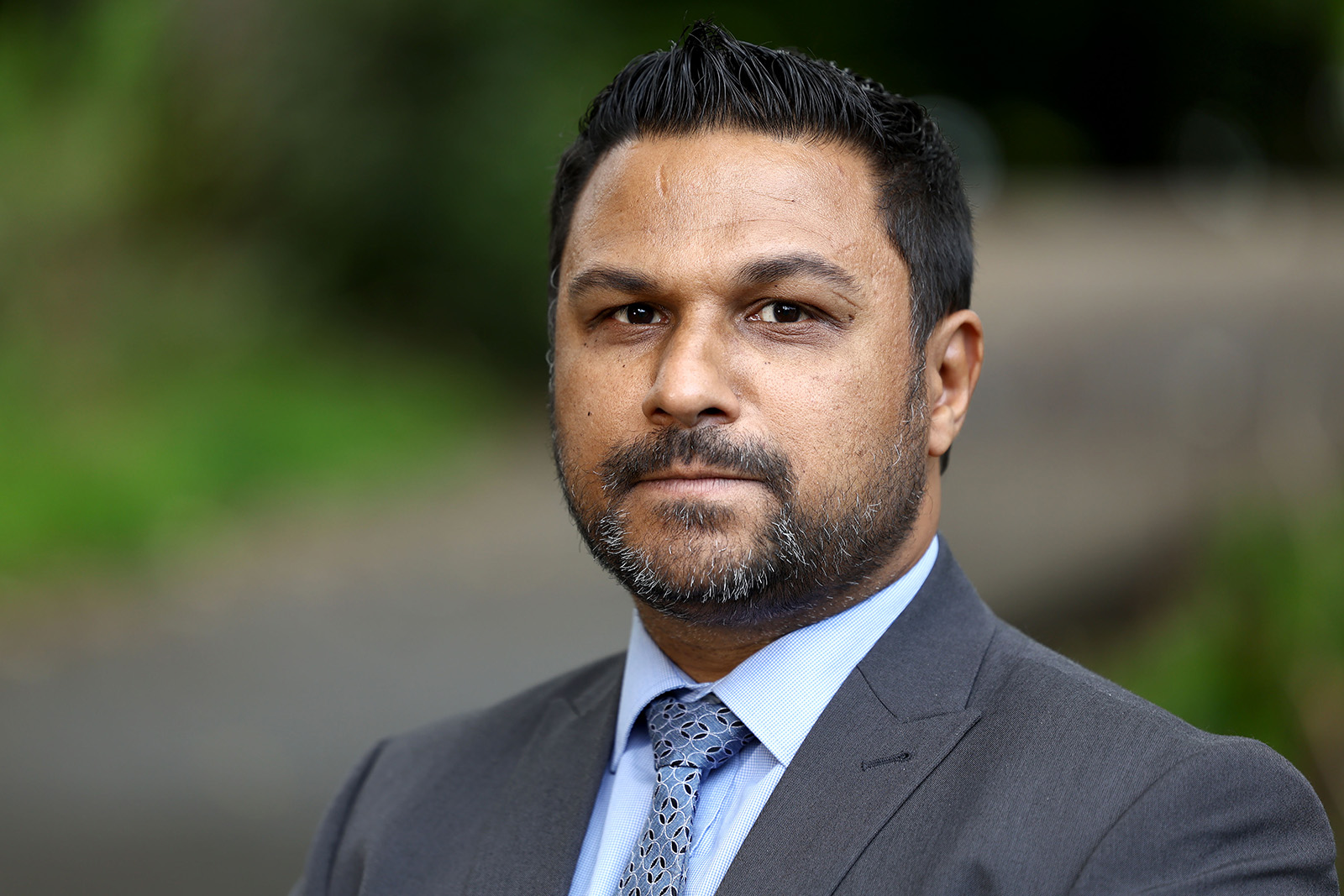 A portrait image of Andy George, president of the National Black Police Association, wearing a suit and tie