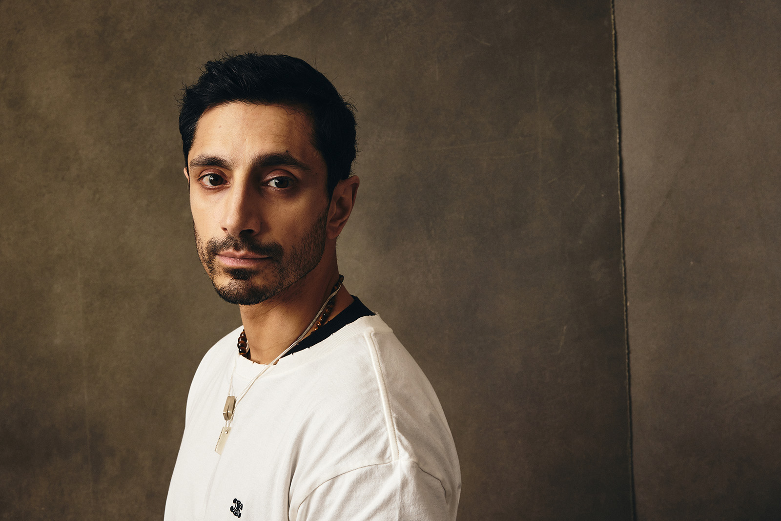 An image of Riz Ahmed, wearing a white top, posing for a Getty Images portrait photograph during SXSW 2026 in Austin, Texas