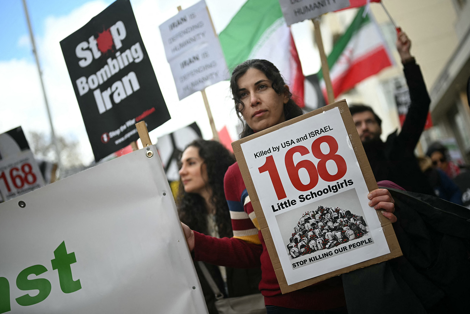 Protesters hold placards during a march organised by the Palestine Coalition in central London on March 28, 2026