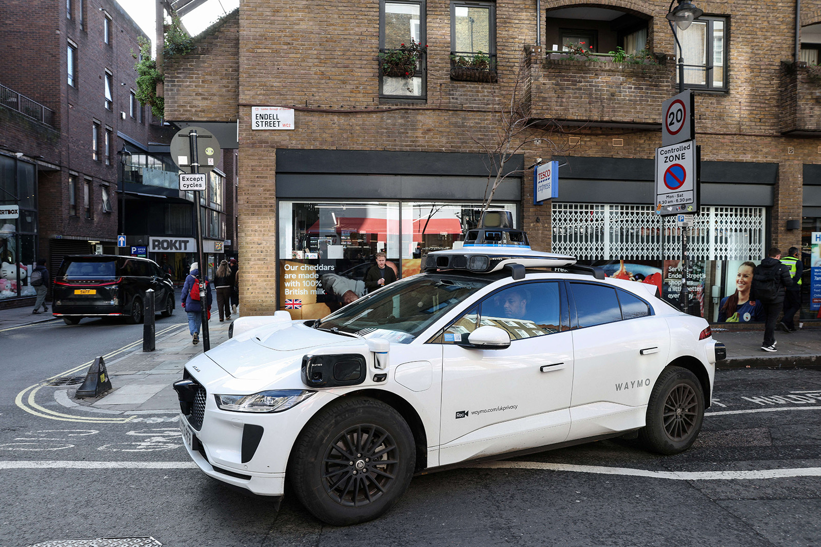 A photograph of a Waymo self-driving car on a street in London, February 2026