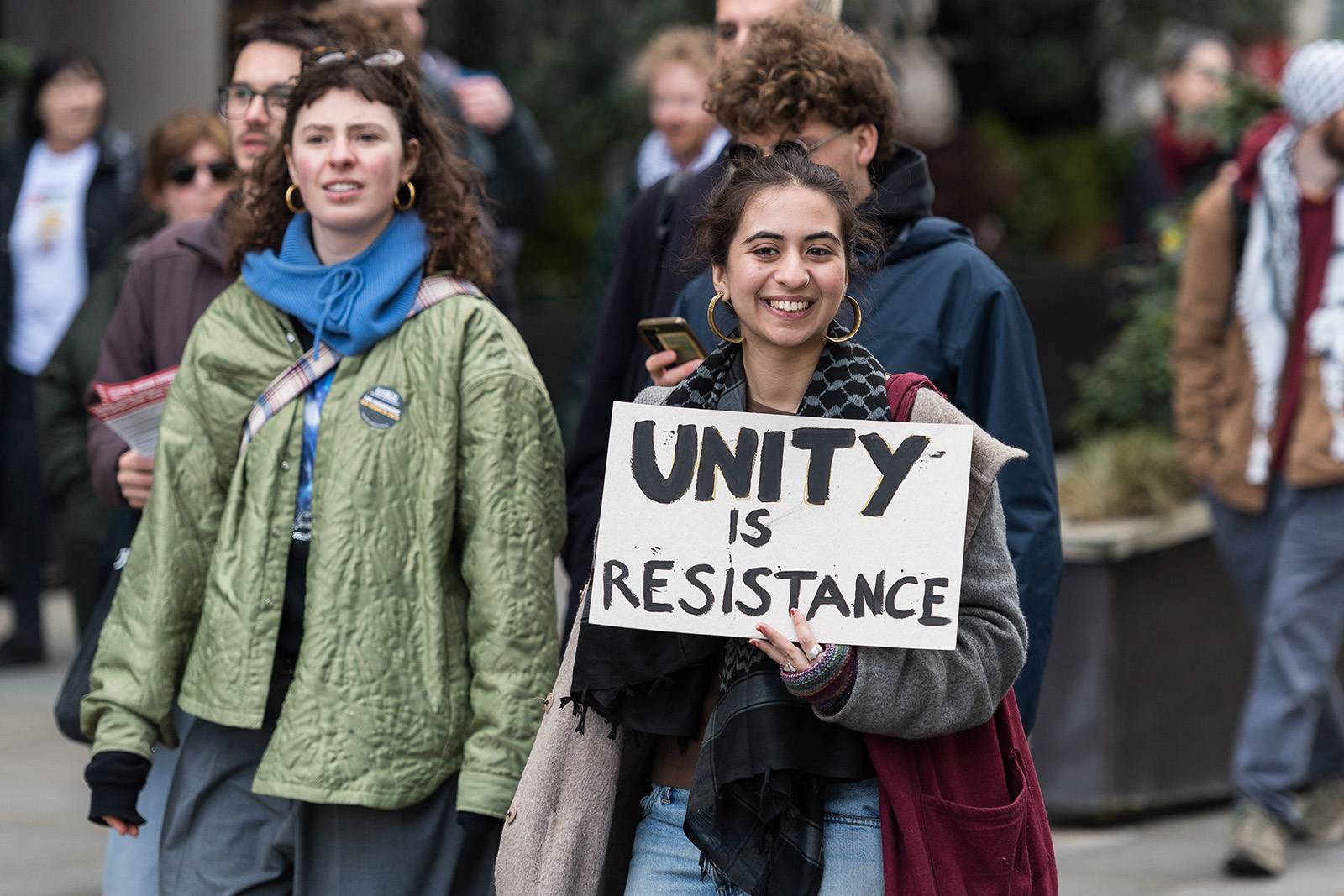 A demonstrator holds a placard, 'Unity is resistance', as thousands take part in a Together Alliance march against the far right in London on 28 March 2026