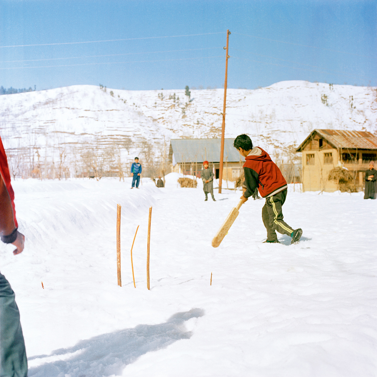 Sohrab Hura, Snow. Photograph shows kids playing cricket in the snow. 