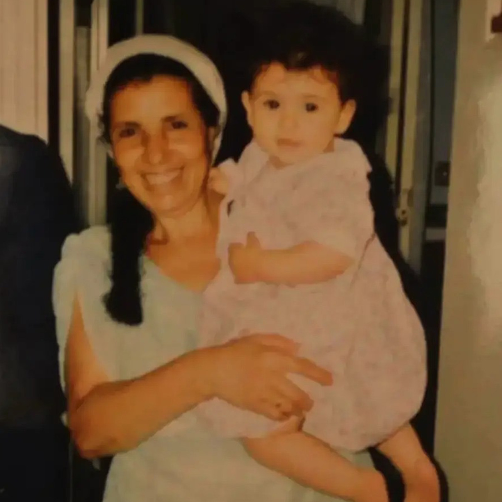 A photgraph of Iman Amrani as a child, being held in her grandmother's arms