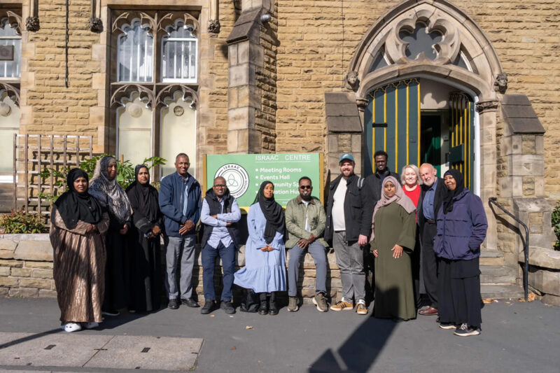 A photograph of Israac Somali Community Association staff outside the Grade II-listed Victorian building in the Sharrow area of Sheffield