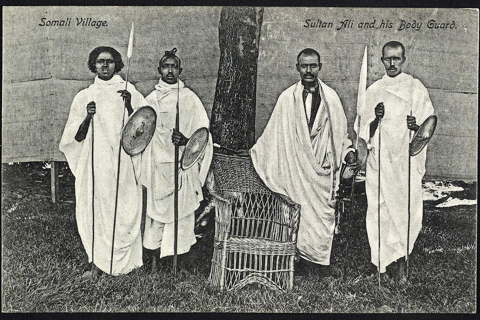 A black and white archive photograph of four Somali men who formed part of the Somali Village troupe at the Bradford Great Exhibition in Lister Park. Sultan Ali al-Urfa (second from right), leader of the Somali Village, selected members of his extended family and clan for the project