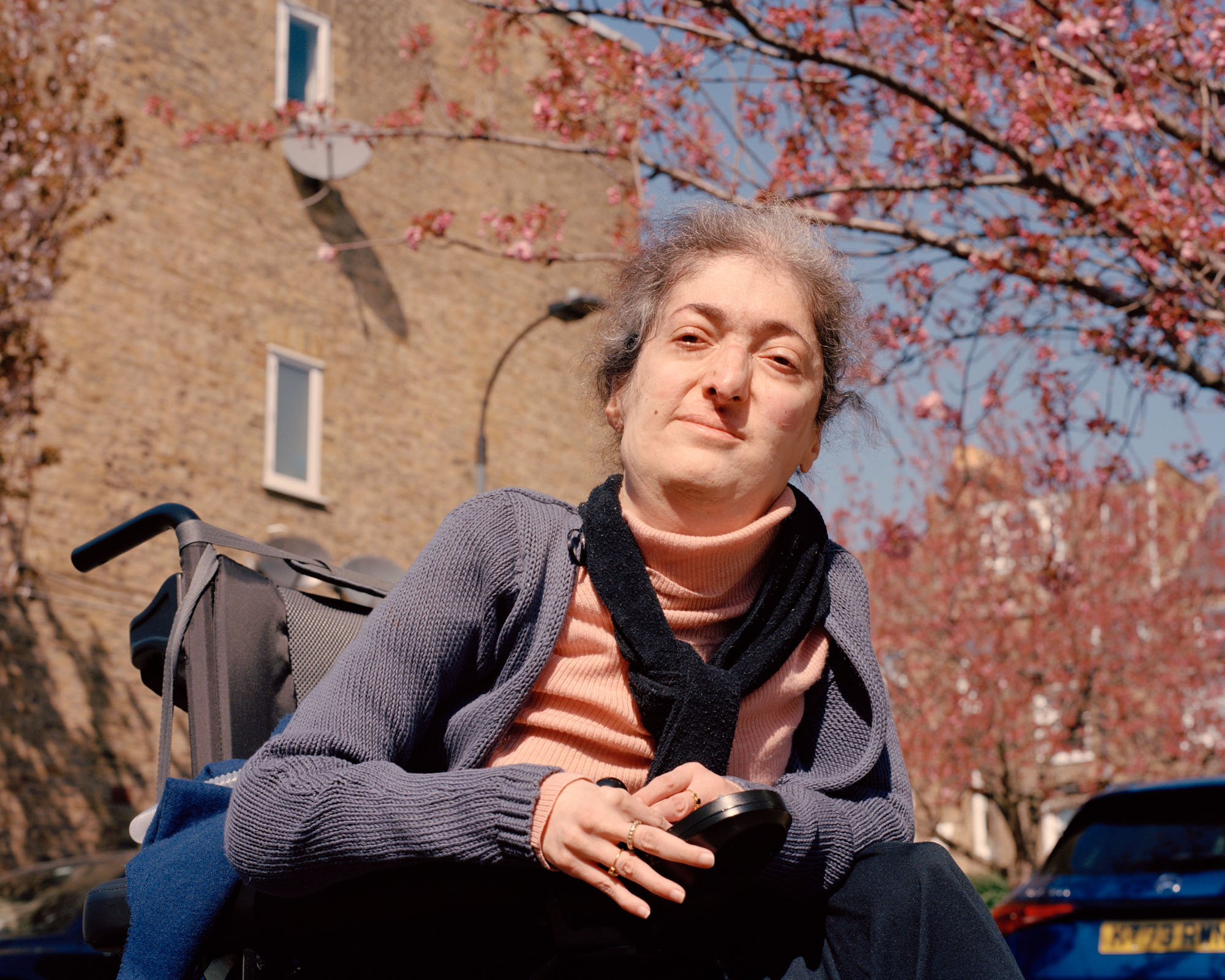 A portrait photograph of writer and disability rights activist Raya Al-Jadir